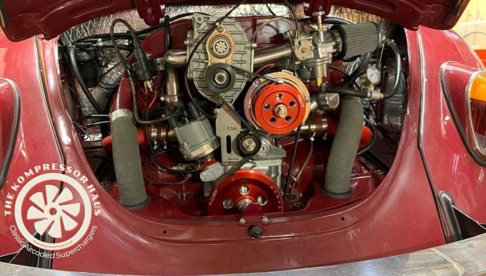 Maroon Beetle engine bay with the AMR 500, twin cone filters and red anodised
                    pulleys.